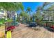 Expansive community deck with multiple picnic tables and umbrellas at 515 30Th W Ave # H201, Bradenton, FL 34205