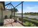 Screened-in patio overlooking lake and community at 224 Babbling Brook Run, Bradenton, FL 34212