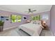 Comfortable bedroom featuring two large windows and neutral furniture and cool wall colors at 5310 N Tuttle Ave, Sarasota, FL 34234