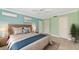 Stylishly staged main bedroom featuring a ceiling fan, and cool blue accent walls at 5310 N Tuttle Ave, Sarasota, FL 34234