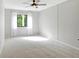 Large bedroom with ceiling fan and window at 1644 Stickney Point Rd # 102, Sarasota, FL 34231