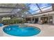 Enclosed pool and spa with a covered patio at 891 Faulkwood Ct, Sarasota, FL 34232