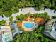 Aerial view showing pool, building, and surrounding landscape at 409 North Point Rd # 902, Osprey, FL 34229