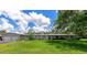 Ranch-style home with a two-car garage and spacious lawn at 5310 N Tuttle Ave, Sarasota, FL 34234