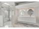 Elegant bathroom featuring double sinks, marble finishes, and a walk-in shower at 4323 Rock Creek Dr, Port Charlotte, FL 33948