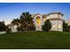 Two-story home exterior with lush landscaping and a three-car garage at 4323 Rock Creek Dr, Port Charlotte, FL 33948