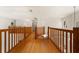 Upstairs hallway with hardwood floors and wooden railings at 4323 Rock Creek Dr, Port Charlotte, FL 33948