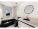 Bathroom with black bathtub and a round mirror at 4323 Rock Creek Dr, Port Charlotte, FL 33948