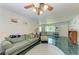 Cozy living room featuring a sofa, armchair, and ceiling fan at 1410 21St W St, Bradenton, FL 34205