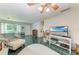 Bright living room featuring tile floors, comfy seating, and a large TV at 1410 21St W St, Bradenton, FL 34205