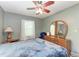 Bedroom with ceiling fan, dresser, and a large bed at 1410 21St W St, Bradenton, FL 34205