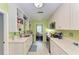 Modern kitchen with white cabinets, stainless steel appliances, and light flooring at 1410 21St W St, Bradenton, FL 34205