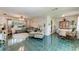 Open living room with green tile floors, sofa, and dining area at 1410 21St W St, Bradenton, FL 34205