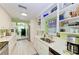 Modern kitchen with white cabinets, stainless steel appliances, and light flooring at 1410 21St W St, Bradenton, FL 34205