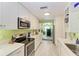 Modern kitchen with white cabinets, stainless steel appliances, and light flooring at 1410 21St W St, Bradenton, FL 34205