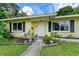 Charming yellow house with a landscaped yard and walkway at 1410 21St W St, Bradenton, FL 34205