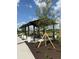 An outdoor pavilion with seating and meticulous landscaping provides a comfortable gathering spot for residents and visitors at 1217 Blue Shell Loop, Sarasota, FL 34240