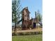 The wooden playground with slides and climbing features provides a creative and active play area for the community's children at 1217 Blue Shell Loop, Sarasota, FL 34240