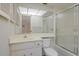 Bright bathroom with white cabinets, shower over tub, and large mirror at 3500 El Conquistador Pkwy # 238, Bradenton, FL 34210