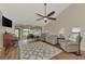Living room with vaulted ceiling, hardwood floors, and patio access at 4521 Kingsmere # 6, Sarasota, FL 34235