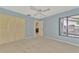Bedroom with light blue walls, ceiling fan, and access to patio at 4521 Kingsmere # 6, Sarasota, FL 34235