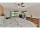 Bright bedroom with a king-size bed and scenic golf course view at 4521 Kingsmere # 6, Sarasota, FL 34235