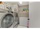 Laundry room with washer, dryer, and ample storage shelving at 4521 Kingsmere # 6, Sarasota, FL 34235
