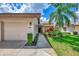 Exterior view of condo with garage and landscaped walkway at 4521 Kingsmere # 6, Sarasota, FL 34235