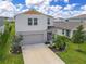 Two-story house with gray siding, yellow accents, and a landscaped yard at 12925 Oak Hill Way, Parrish, FL 34219