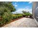 Relaxing backyard patio with lush landscaping and a view of the neighborhood at 4405 Lenox Blvd, Venice, FL 34293