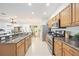 Open kitchen with granite countertops and stainless steel appliances at 4405 Lenox Blvd, Venice, FL 34293