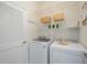 Well-equipped laundry room with washer, dryer, and ample shelving at 4405 Lenox Blvd, Venice, FL 34293