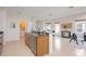 Modern kitchen with island, stainless steel appliances, and laundry access at 4405 Lenox Blvd, Venice, FL 34293