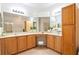 Double vanity bathroom with wood cabinets and a soaking tub at 4405 Lenox Blvd, Venice, FL 34293