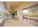 Screened porch with tiled floor and patio furniture at 4405 Lenox Blvd, Venice, FL 34293