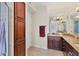 Elegant bathroom with dark wood cabinets, granite countertops, and a large mirror at 7962 Tybee Ct, University Park, FL 34201