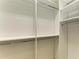 Spacious walk-in closet with custom shelving and rods at 2942 Trustee Ave, Sarasota, FL 34243