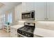 Kitchen island with sink and stainless steel appliances at 2942 Trustee Ave, Sarasota, FL 34243