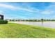 Lake view backyard with lush green grass at 2942 Trustee Ave, Sarasota, FL 34243