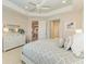 Main bedroom with a king-size bed, dresser, and access to the bathroom and kitchen at 2942 Trustee Ave, Sarasota, FL 34243