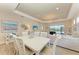 Elegant dining room with white table and chairs, view to backyard at 2942 Trustee Ave, Sarasota, FL 34243