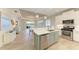 Modern kitchen with island, stainless steel appliances, and white cabinets at 2942 Trustee Ave, Sarasota, FL 34243
