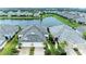 Aerial view of houses with gray roofs and a community lake at 2942 Trustee Ave, Sarasota, FL 34243