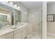 Bathroom with a large walk-in shower and double vanity at 2942 Trustee Ave, Sarasota, FL 34243
