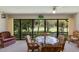 Dining area with a glass-top table and chairs overlooking the golf course at 3500 El Conquistador Pkwy # 238, Bradenton, FL 34210