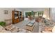 Living room with floral sofas and view of patio and golf course at 3500 El Conquistador Pkwy # 238, Bradenton, FL 34210