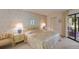 Bright bedroom with a queen-size bed and access to a private balcony at 3500 El Conquistador Pkwy # 238, Bradenton, FL 34210