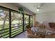 Dining area with a glass-top table and chairs overlooking the golf course at 3500 El Conquistador Pkwy # 238, Bradenton, FL 34210