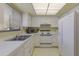 Retro kitchen with white appliances and yellow patterned walls at 3500 El Conquistador Pkwy # 238, Bradenton, FL 34210