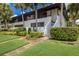 Two-story condo building with lush landscaping at 3500 El Conquistador Pkwy # 238, Bradenton, FL 34210